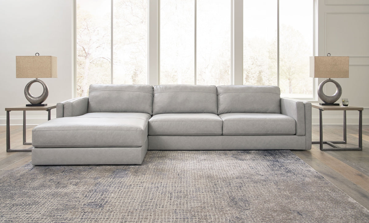 Light gray upholstered sectional sofa with corner chaise and matching seat ottoman