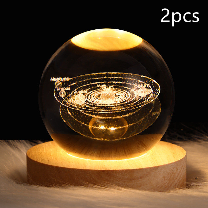 LED crystal ball table lamp on wood base with golden solar-system orbit light