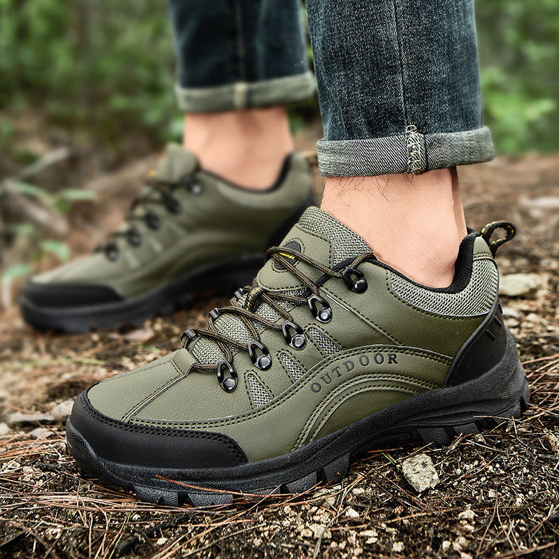 Men's olive hiking sneakers on rocky ground, lace-up with durable tread and laces