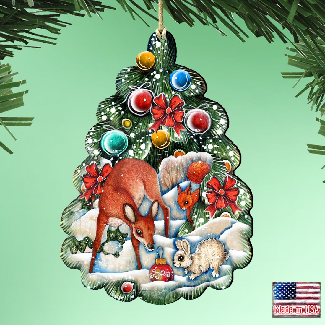 Hanging wooden Christmas tree ornament with forest animals, red bows, and blue and gold baubles