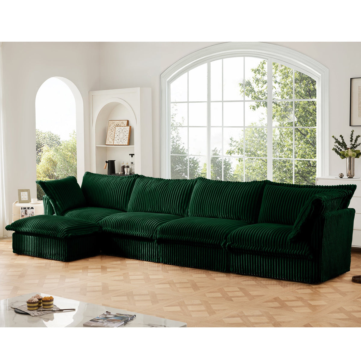 Green L-shaped sectional sofa with left-side chaise, ribbed slipcover, tufted-style seat cushions.
