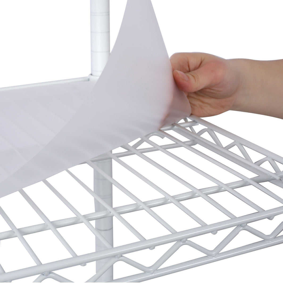 White shelf liner fitting into a wire shelf grid on a metal shelving unit