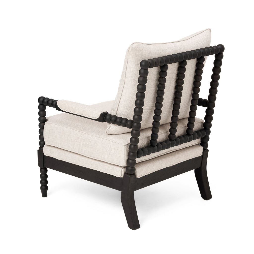 Rear three-quarter view of an accent chair with black beaded frame and cream upholstery
