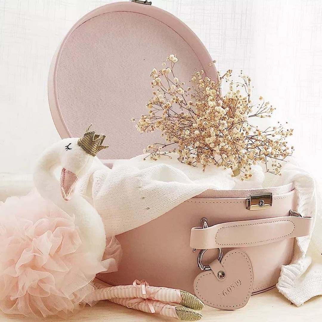 Blush pink round keepsake box open with gold clasp, tulle, and dried flowers