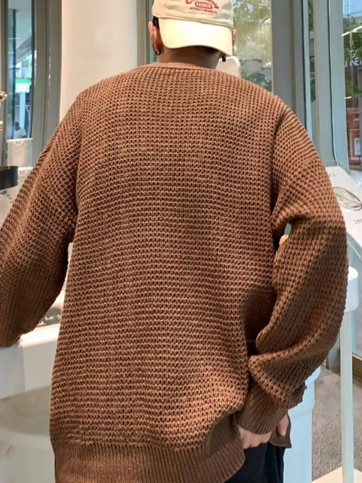 Brown waffle-knit crewneck sweater, back view with ribbed hem and long sleeves
