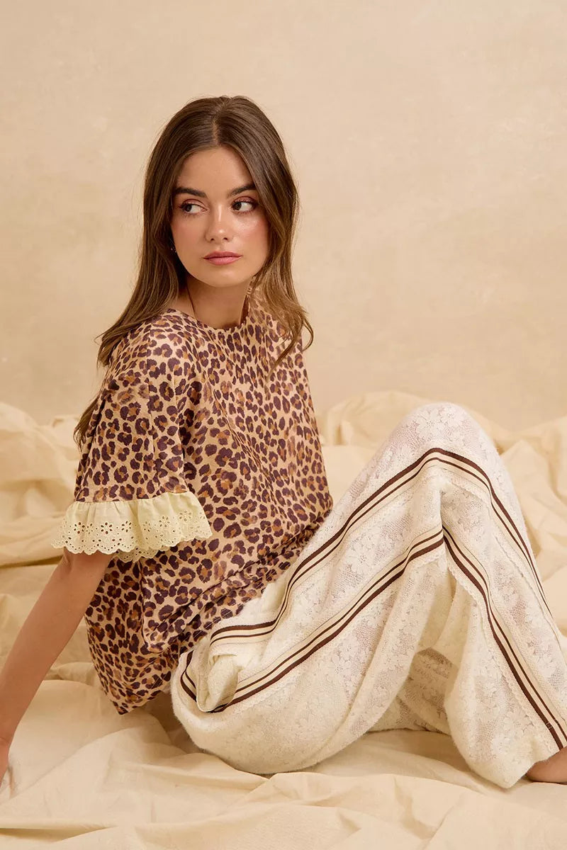 Leopard print ruffled top with eyelet lace trim paired with striped drawstring shorts