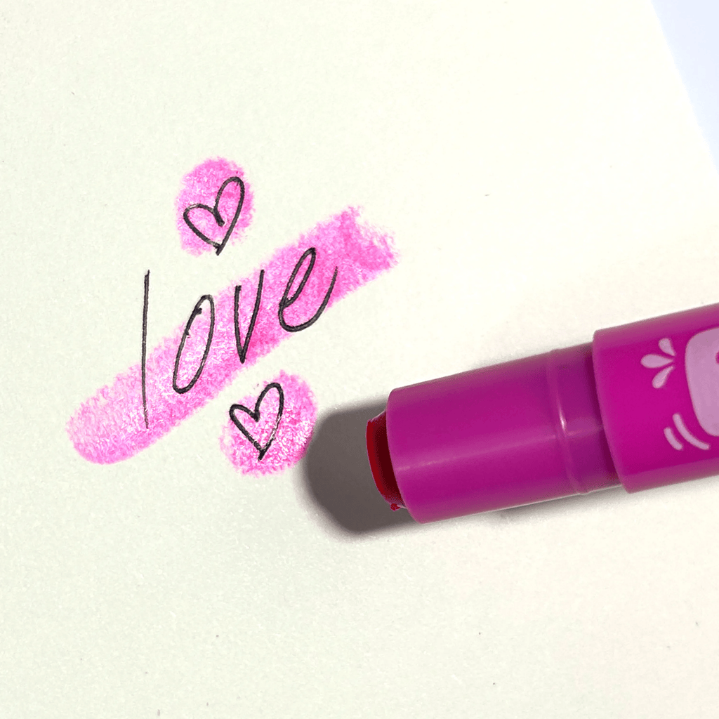 Purple neon gel crayon drawing hearts and “love” on white paper