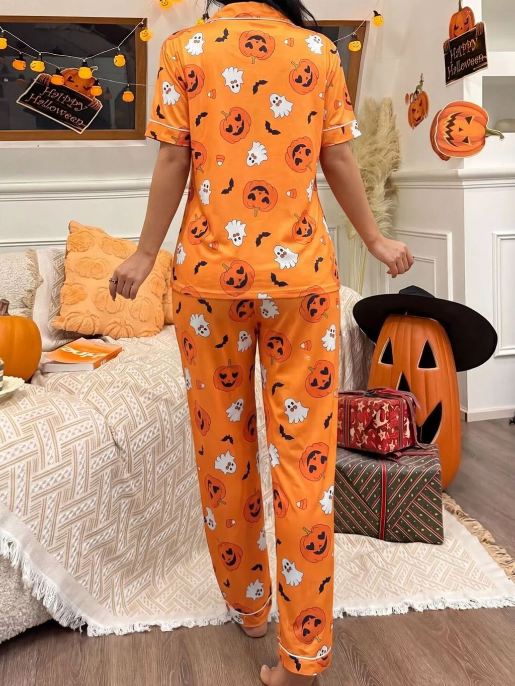 Orange Halloween button-front pajama set with pumpkin-face and ghost motifs, matching pants
