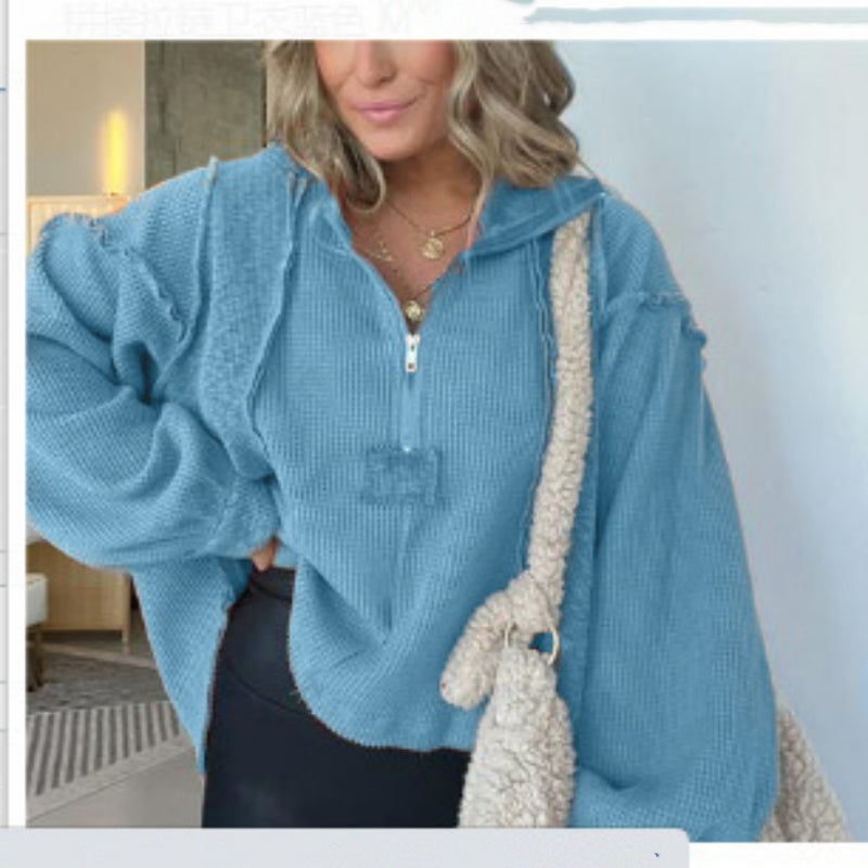 Women's blue short knit sweater with half-zip and frayed hem