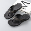 Men's black flip-flop sandals with orange perforated strap on textured footbeds