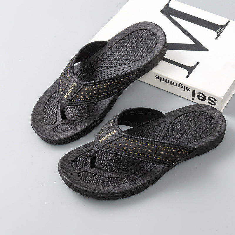 Men's black flip-flop sandals with orange perforated strap on textured footbeds