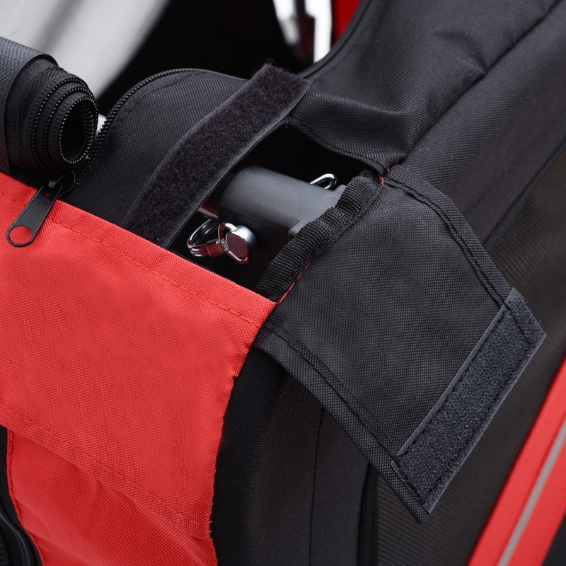 Pet trailer interior seat with black safety straps and red fabric side panel