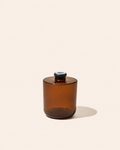 Aura® diffuser bottle in translucent amber with dark circular top