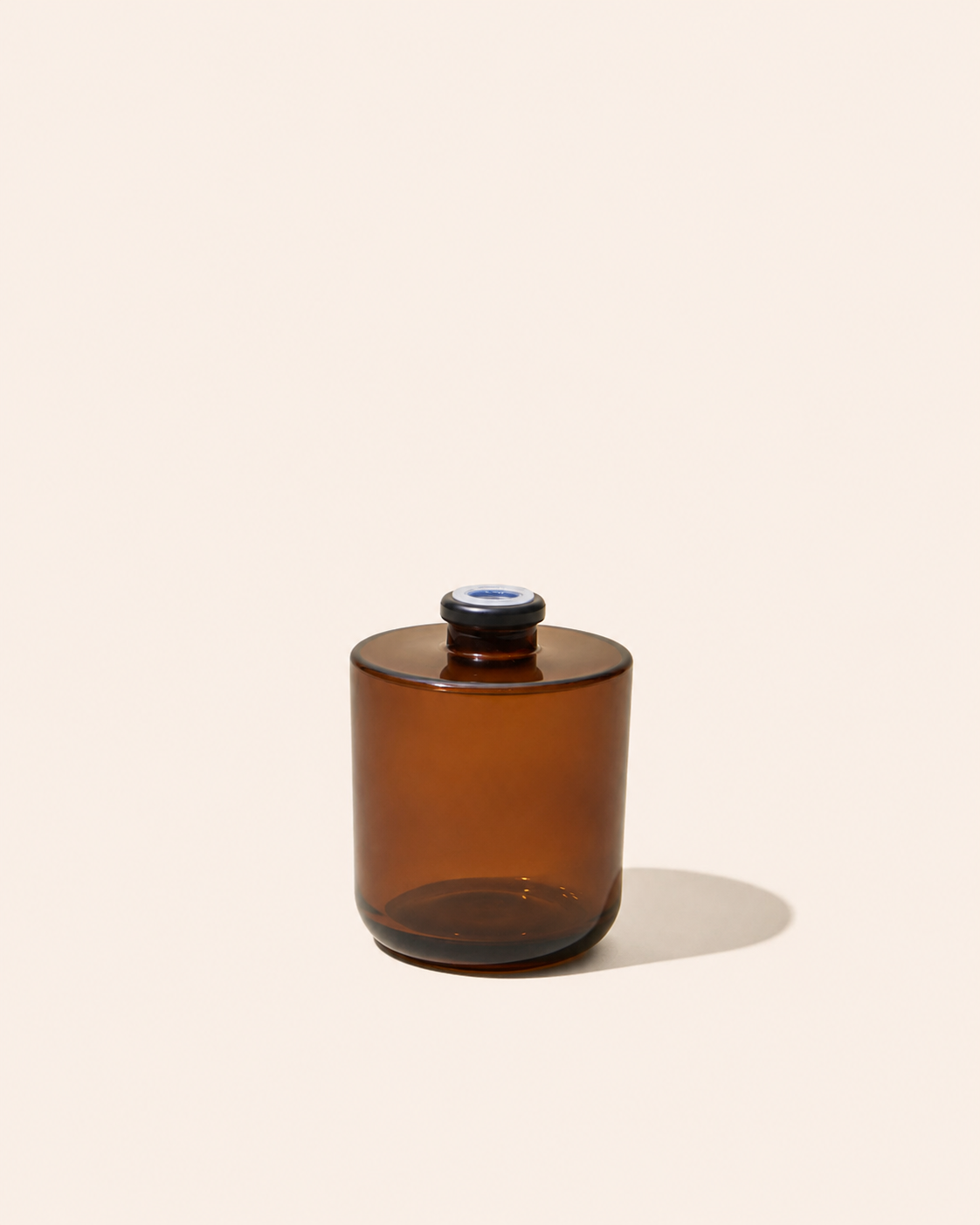 Aura® diffuser bottle in translucent amber with dark circular top