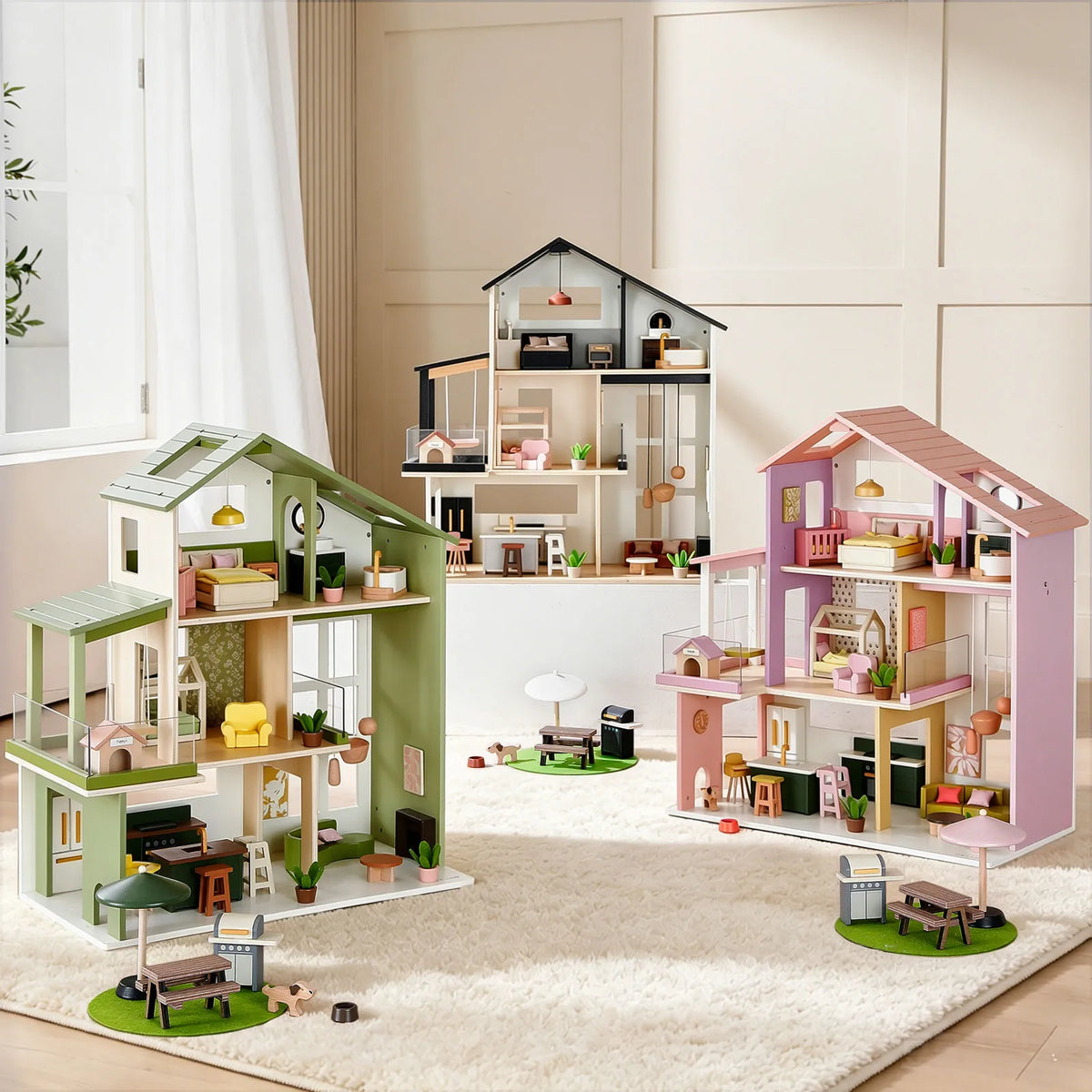Green and pink dollhouses with open rooms and miniature furniture on play mat