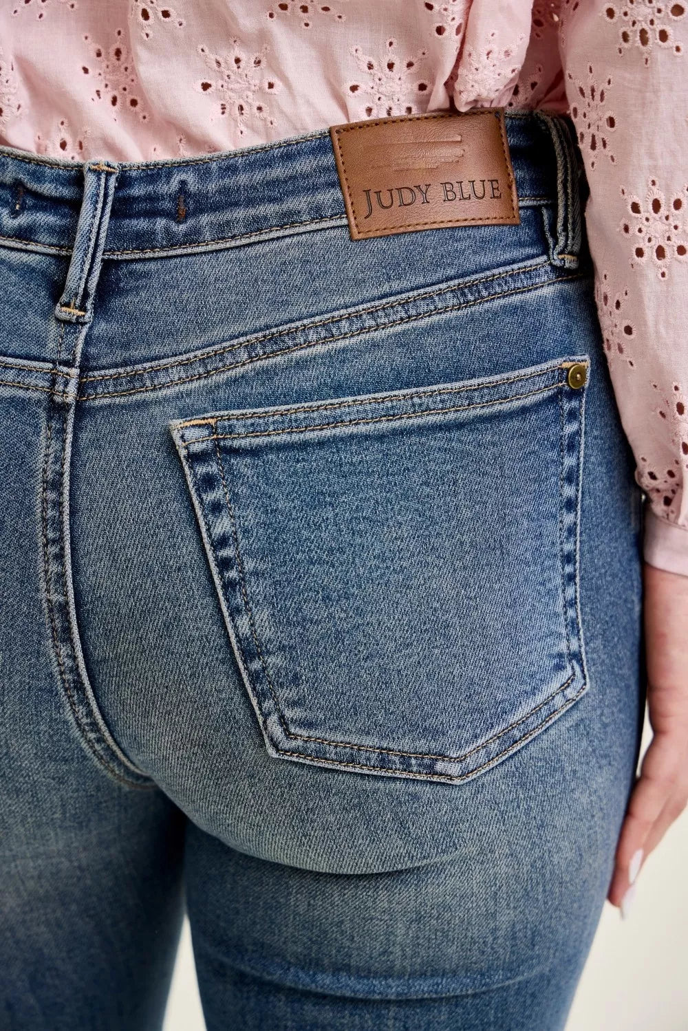 Blue denim jeans front flap pocket with 'Judy Blue' label patch