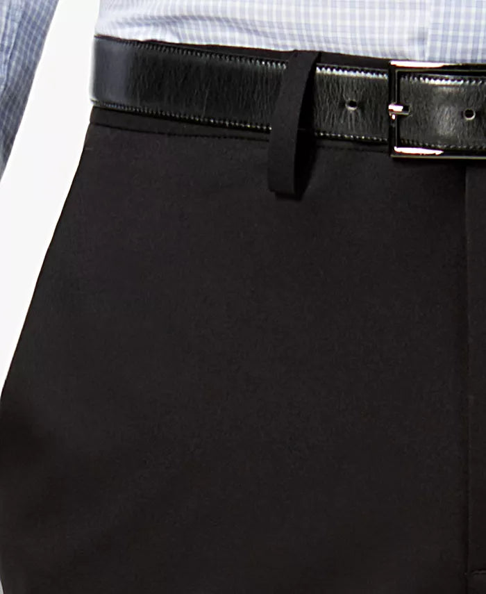 Black stretch pants waistband closeup with belt loops and polished buckle hardware