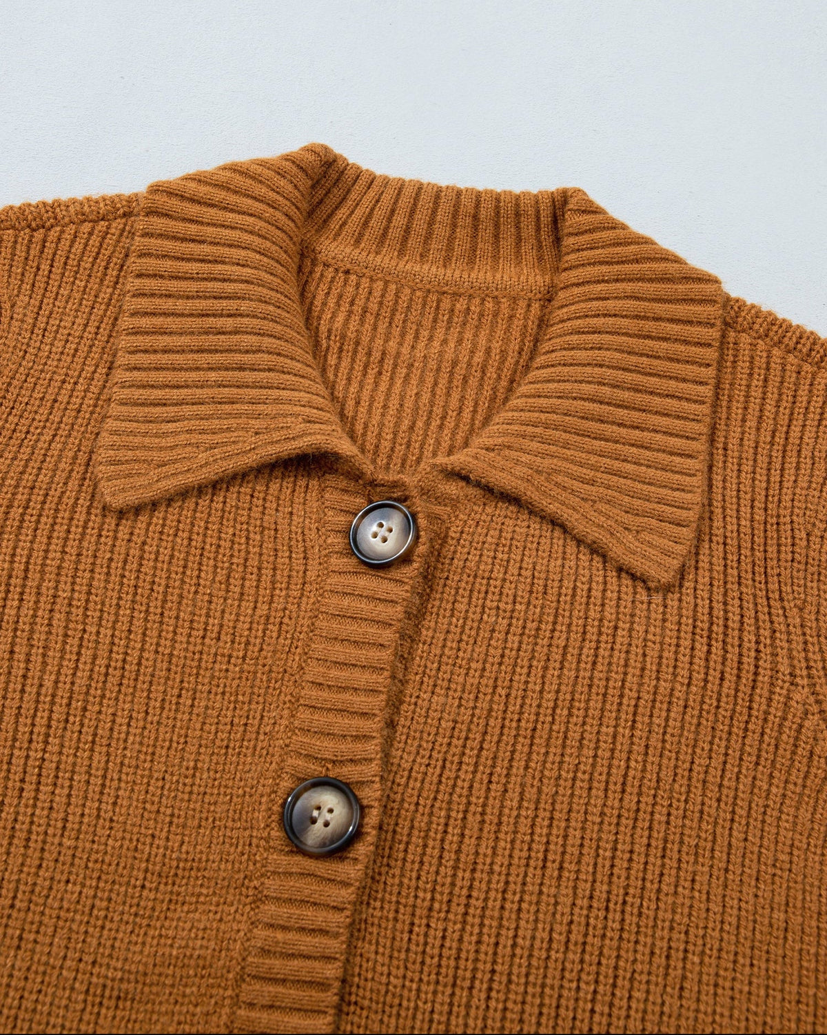 Tan ribbed knit cardigan button-front placket with folded collared neckline, close-up