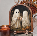 Arched framed Halloween art with two ghost figures holding coffee mugs, on wooden stand