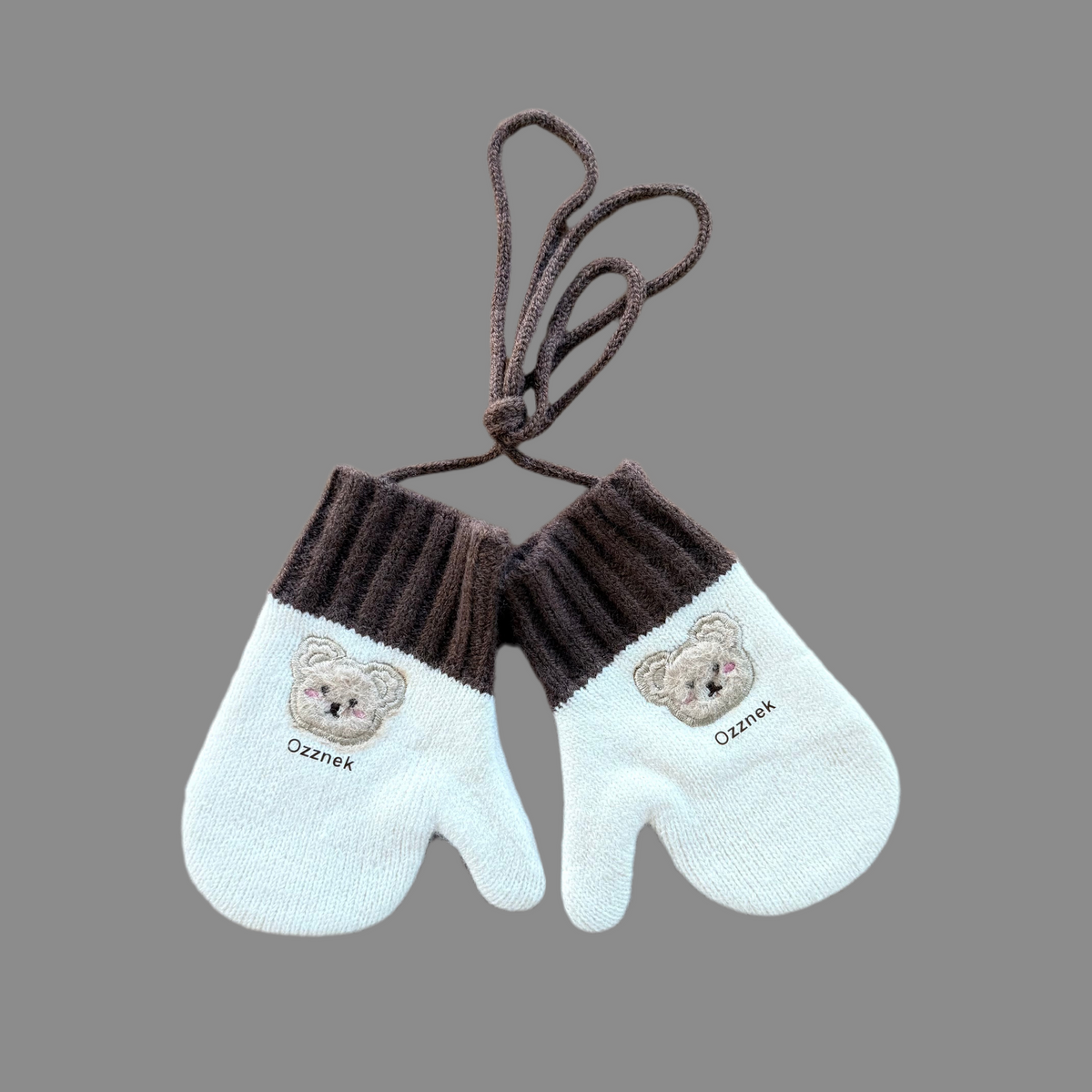 Kids winter mittens with light cream knit, dark brown ribbed cuffs, and bear patches