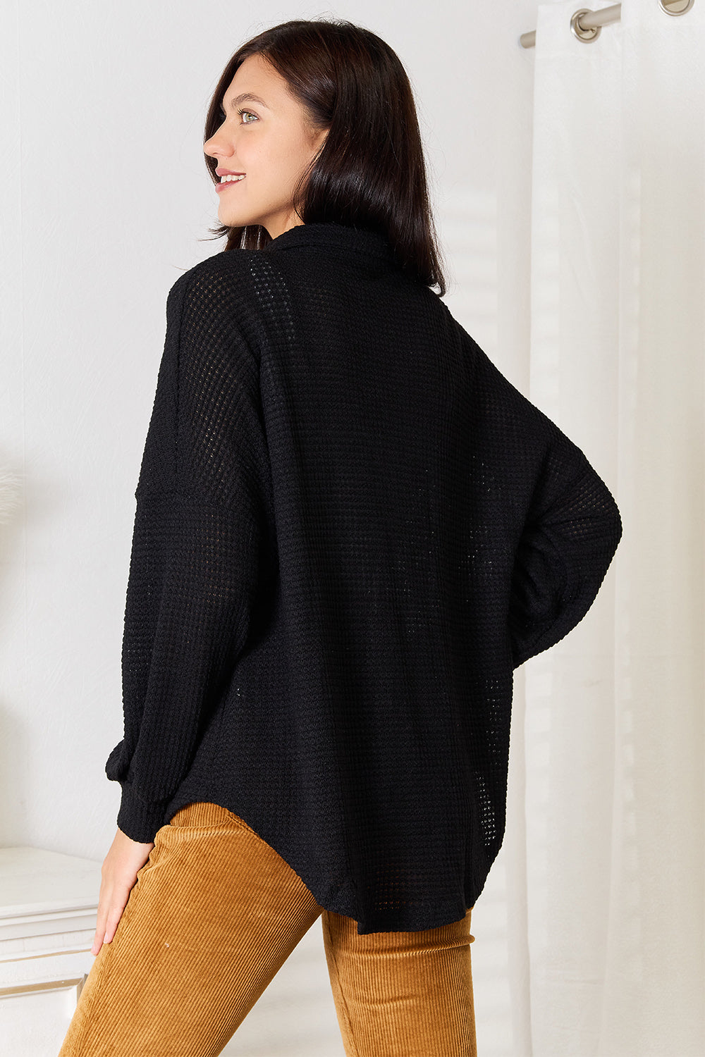 Black waffle-knit collared shirt, view from back with long sleeves and button placket
