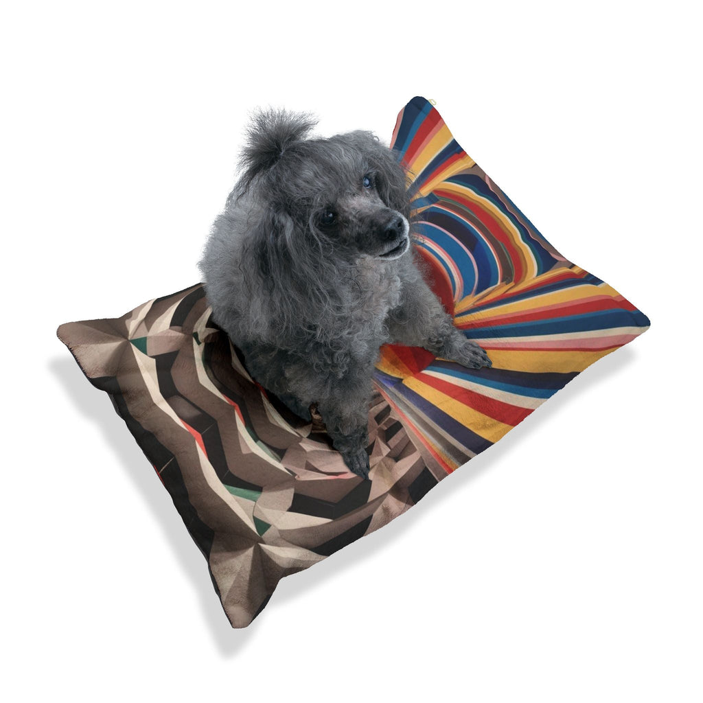 Plush pet bed with geometric abstract print; small gray dog resting on top