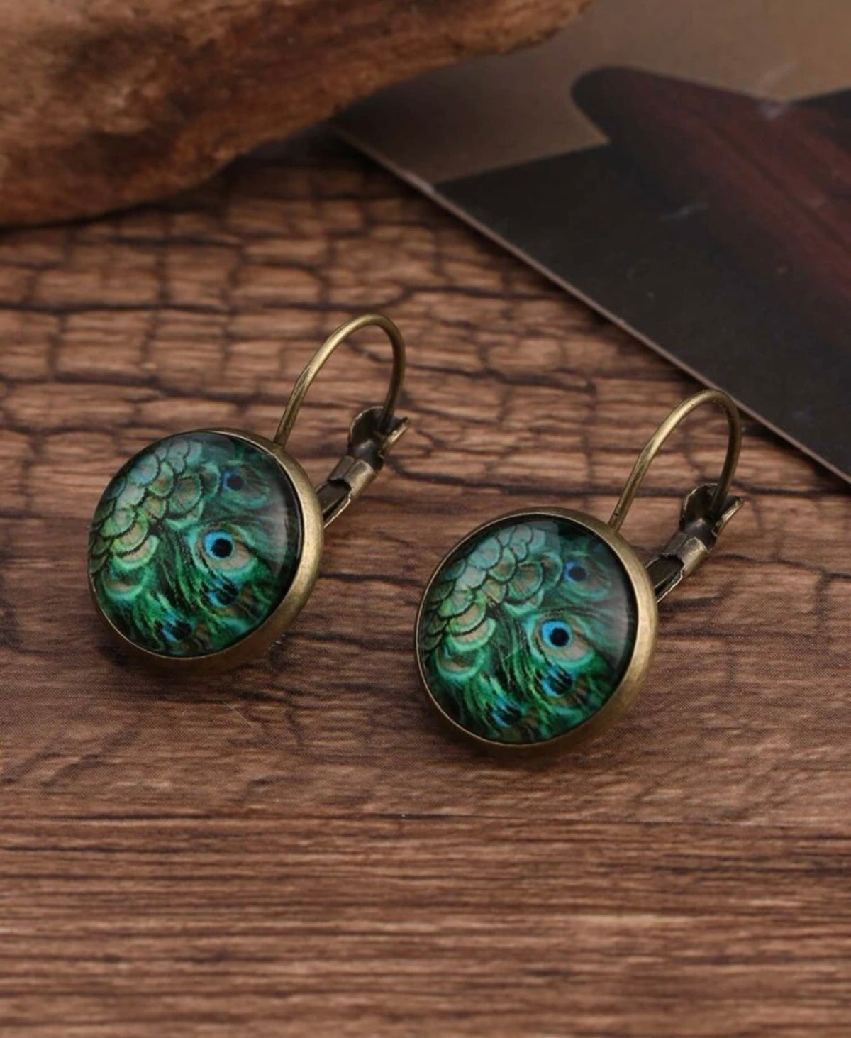 Set of round peacock-feather earrings with bronze hooks, teal green cabochons