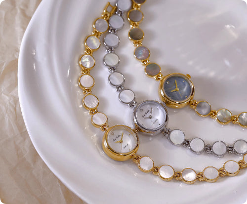 Set of gold and silver watch bracelets with round dials and oval shell links