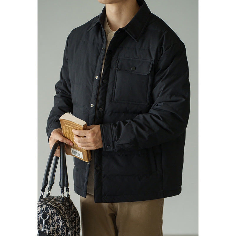 Men's short puffer jacket in black with baseball collar, chest pocket, and padded front