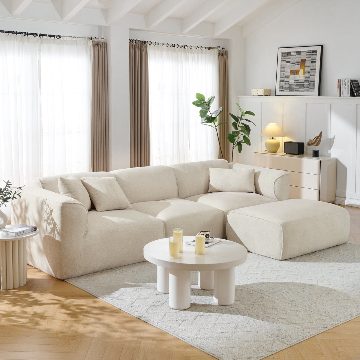 Light beige sectional sofa with ottoman section and matching throw pillows