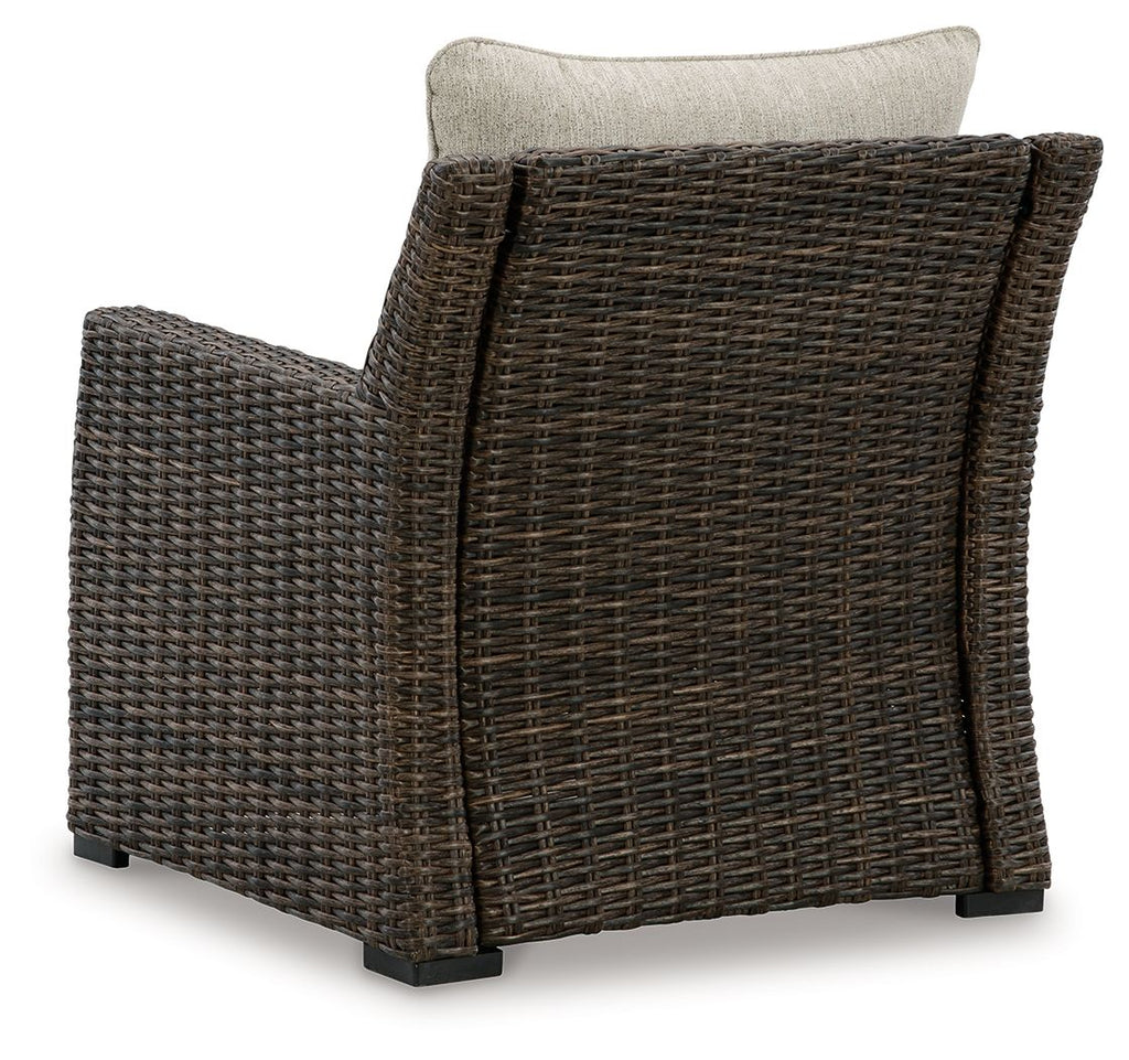 Brown woven lounge chair with beige back cushion, angled side view