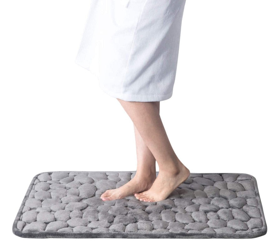 Gray bathroom bath mat with raised pebble-texture pattern, non-slip base