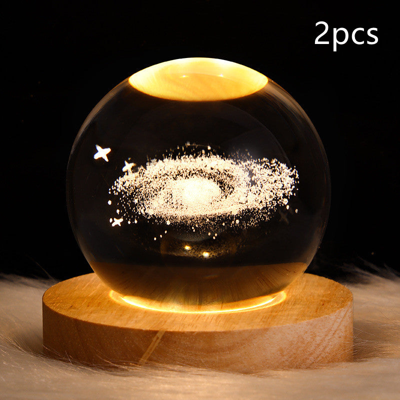 LED galaxy crystal ball table lamp with golden glowing galaxy swirl on wood base