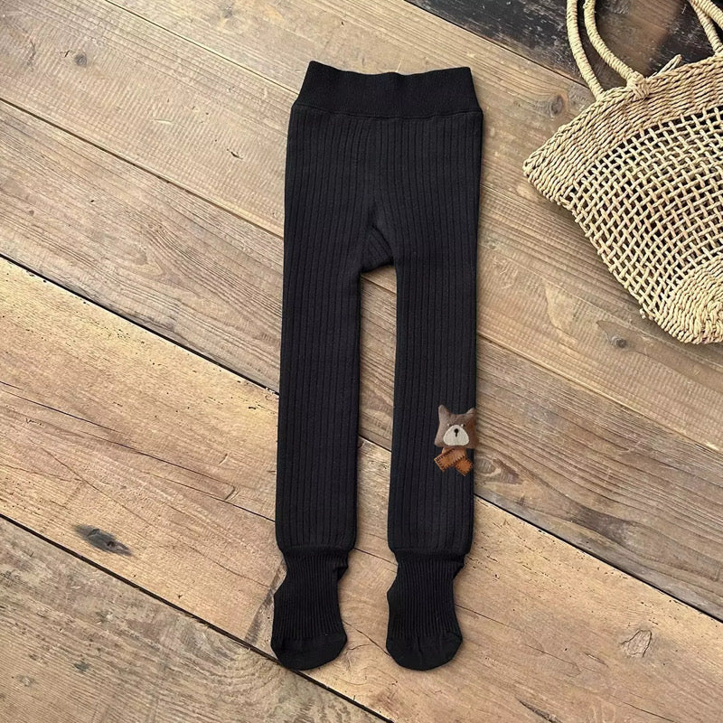 Black fleece-lined ribbed footed leggings with bear patch, shown standing upright