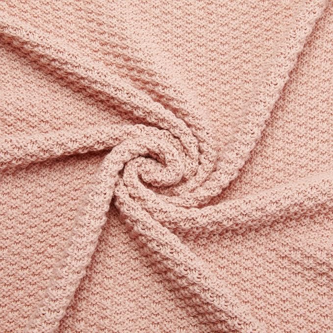 Close-up of dusty rose chunky knit throw blanket with cable texture detail