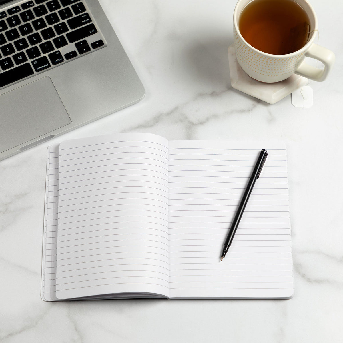 Open lined notebook journal with black pen on top