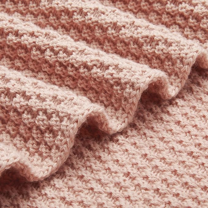 Close-up of dusty rose chunky cable knit throw blanket weave and texture