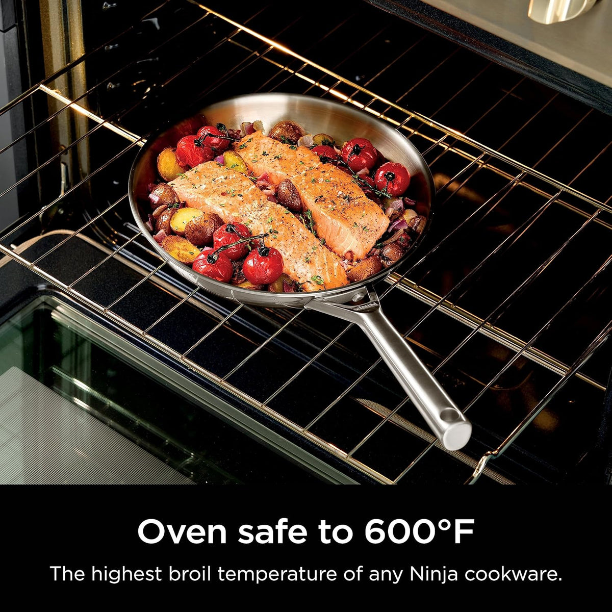 Stainless steel frying pan roasting in oven on wire rack with food inside