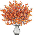 Orange artificial baby's breath bouquet with many tiny blossoms in vase