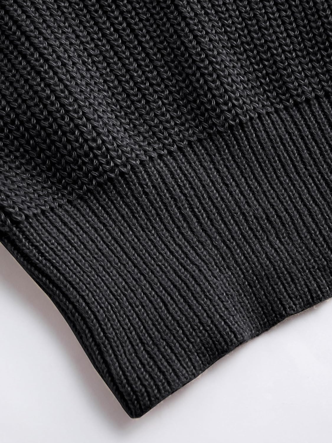 Black mock neck sleeveless sweater vest with ribbed hem and clean knit trim