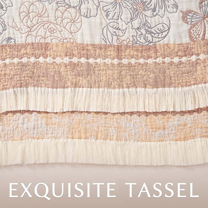 Edge close-up of taupe-and-white blanket with scalloped trim and long tassel fringe