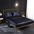 Satin bedding set with dark navy sheet and matching pillowcases, 4-piece set