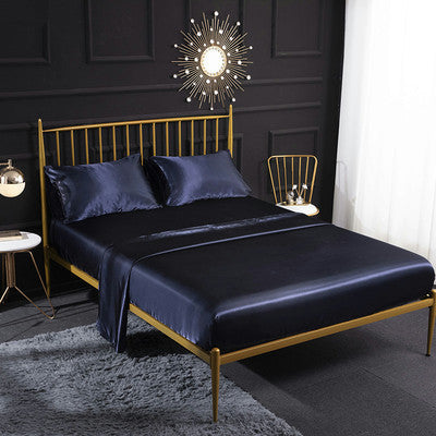Satin bedding set with dark navy sheet and matching pillowcases, 4-piece set