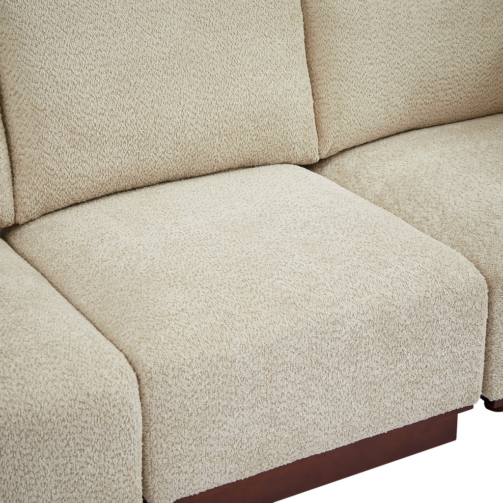 Boucle seat cushion with rounded arm and dark wood base on modular sectional