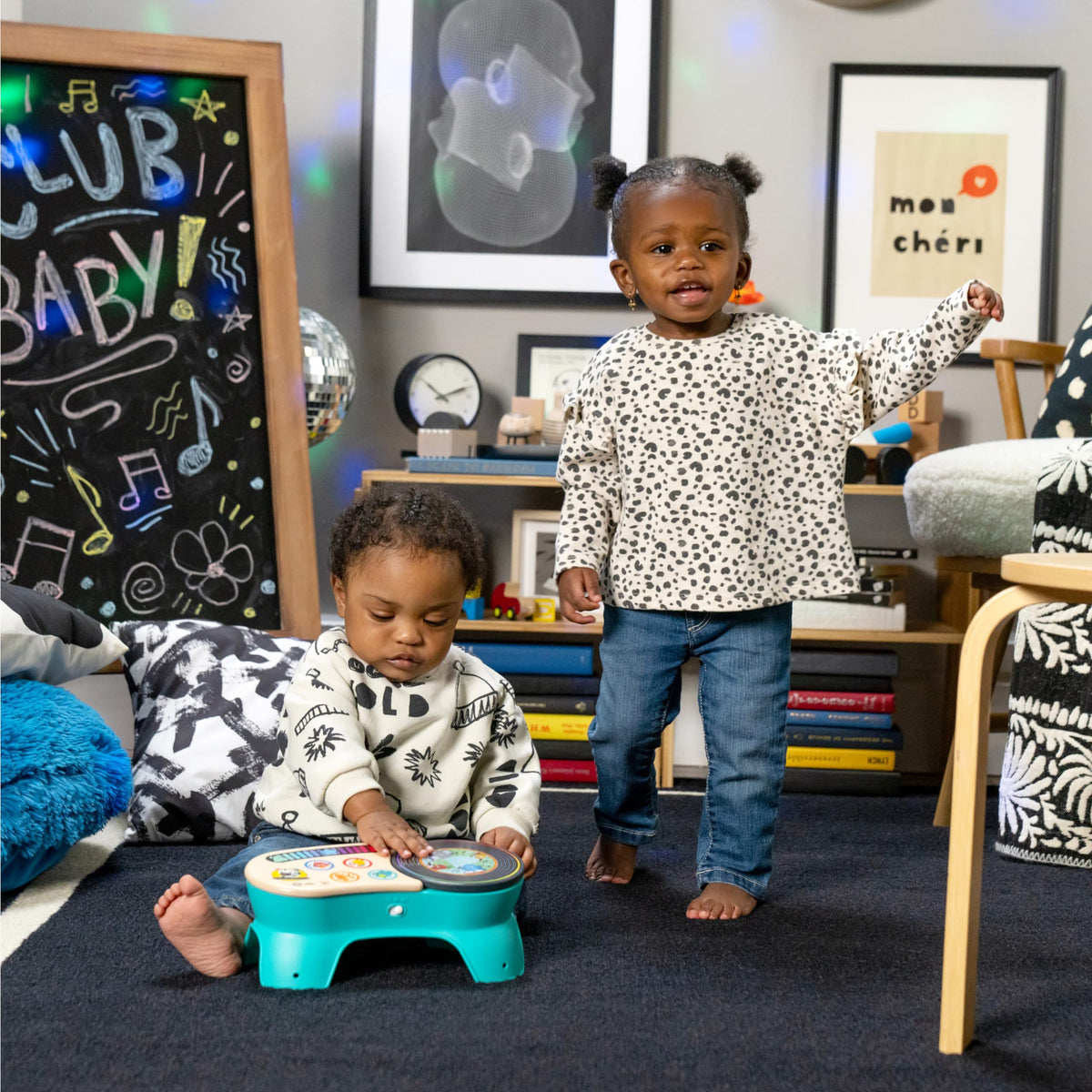 Kids playing with teal toddler discovery stool on carpet; wooden top with colorful icons