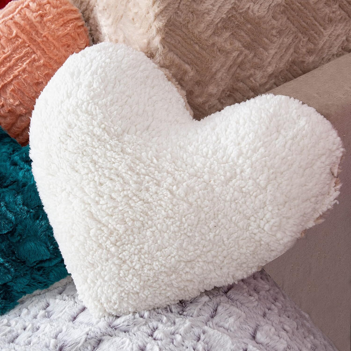 White plush heart throw pillow with thick, fuzzy sherpa-like texture