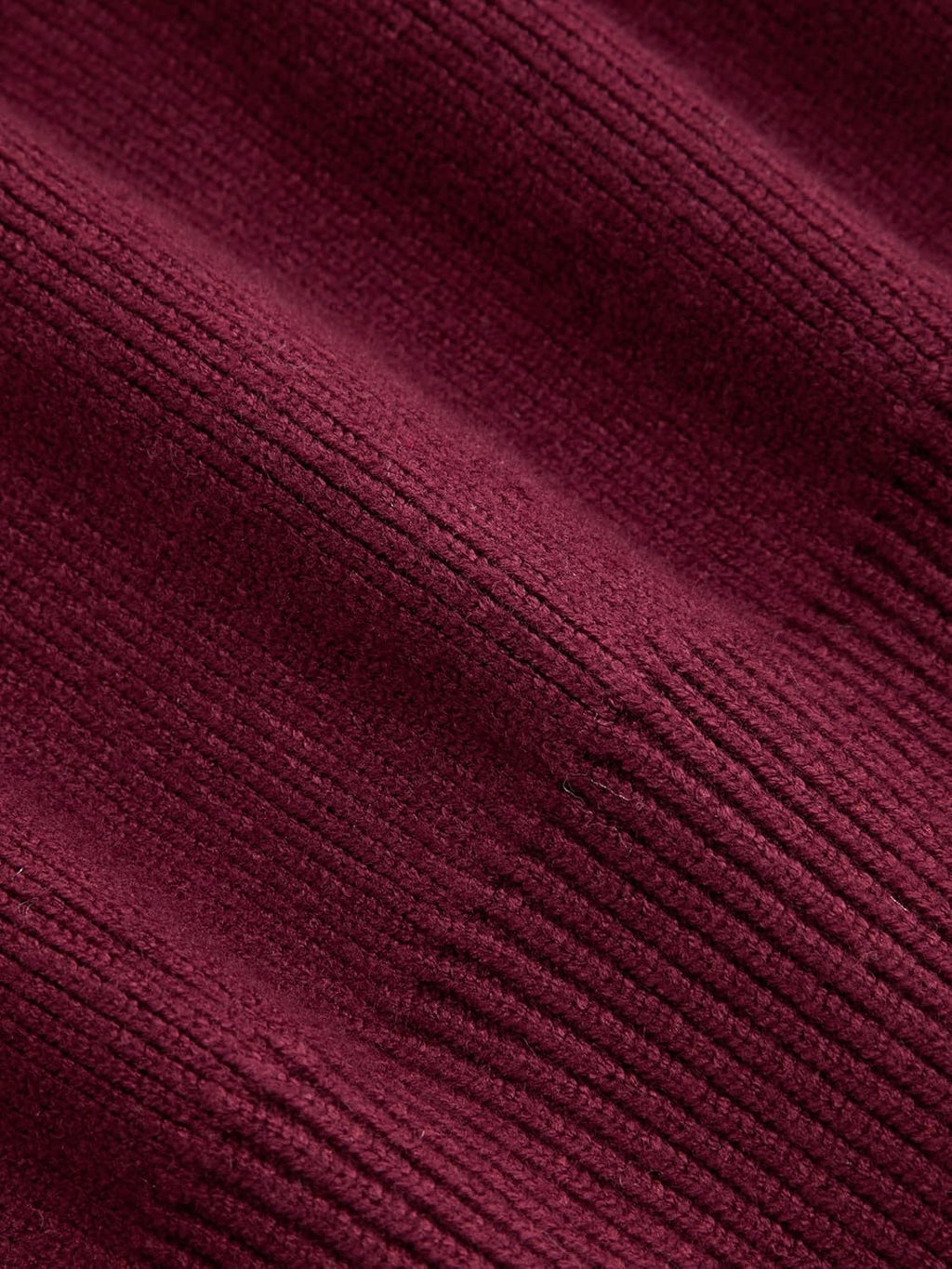 Wine red knitted cardigan fabric texture close-up with fine ribbed pattern