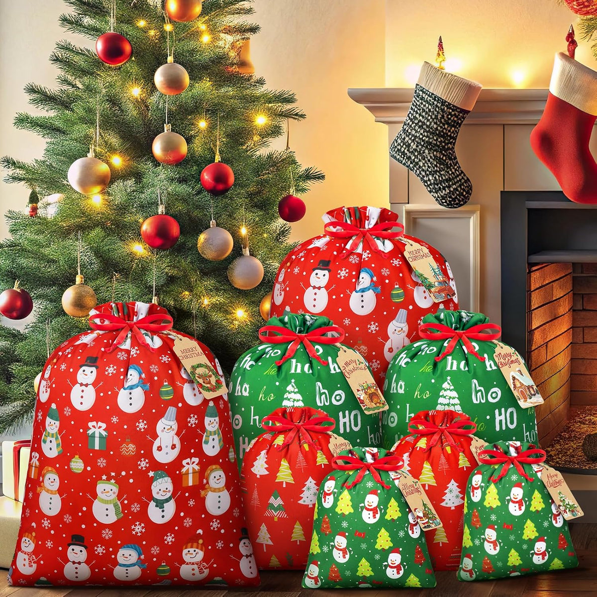 Three Christmas fabric drawstring gift bags with red bows, by a decorated tree