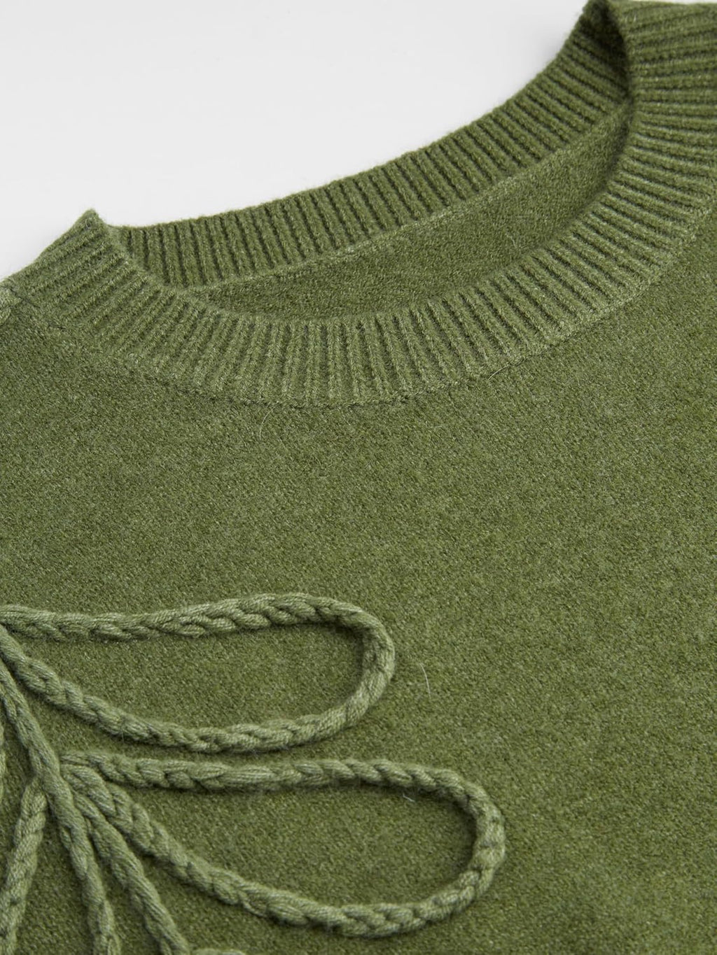 Close-up of olive green knit sweater collar and looped leaf embroidery detail