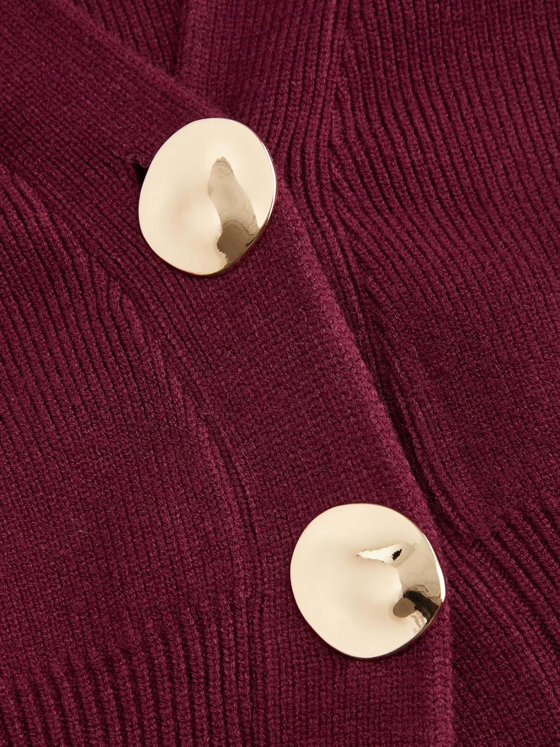 Wine red knitted cardigan close-up with two gold-tone buttons at the front